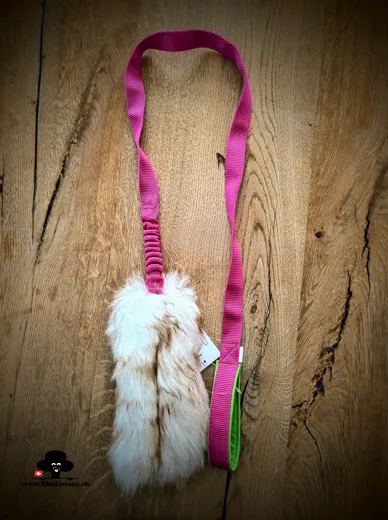Sheepskin mouflon fur tug toy with bungee handle on long webbing
